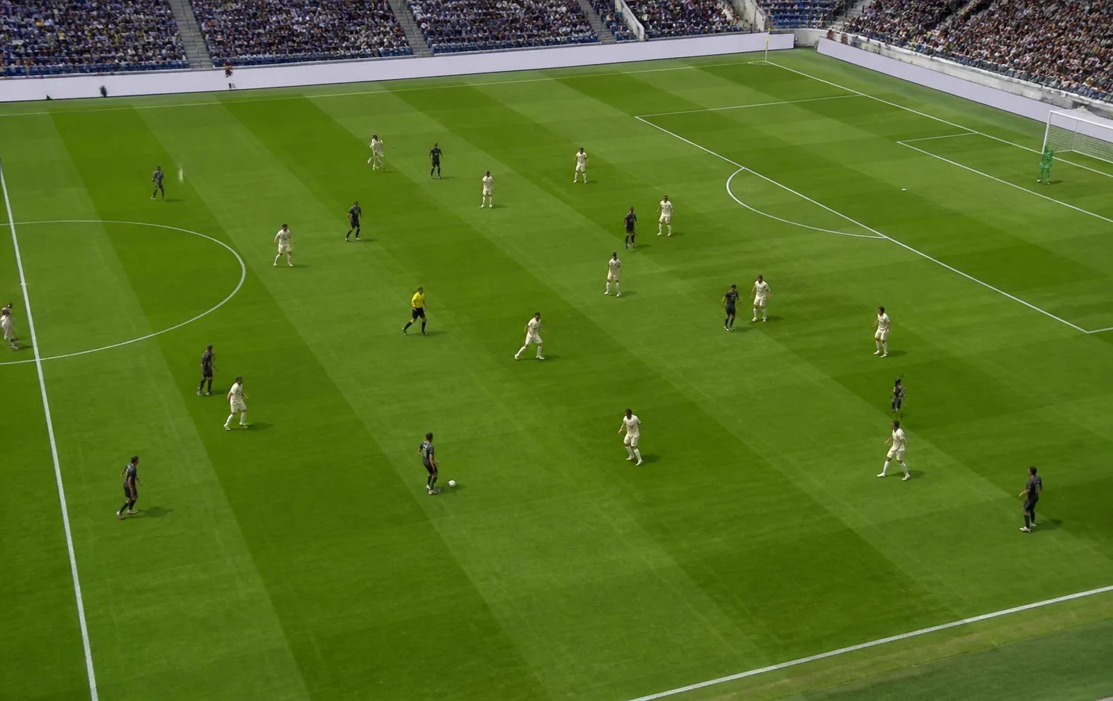Elevated daylight view of a football match showing both teams spread across the pitch in tactical shape